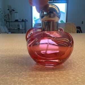Nina Ricci Apple ๐ scent red and Silver Perfume Bottle. Has perfume in bottle.